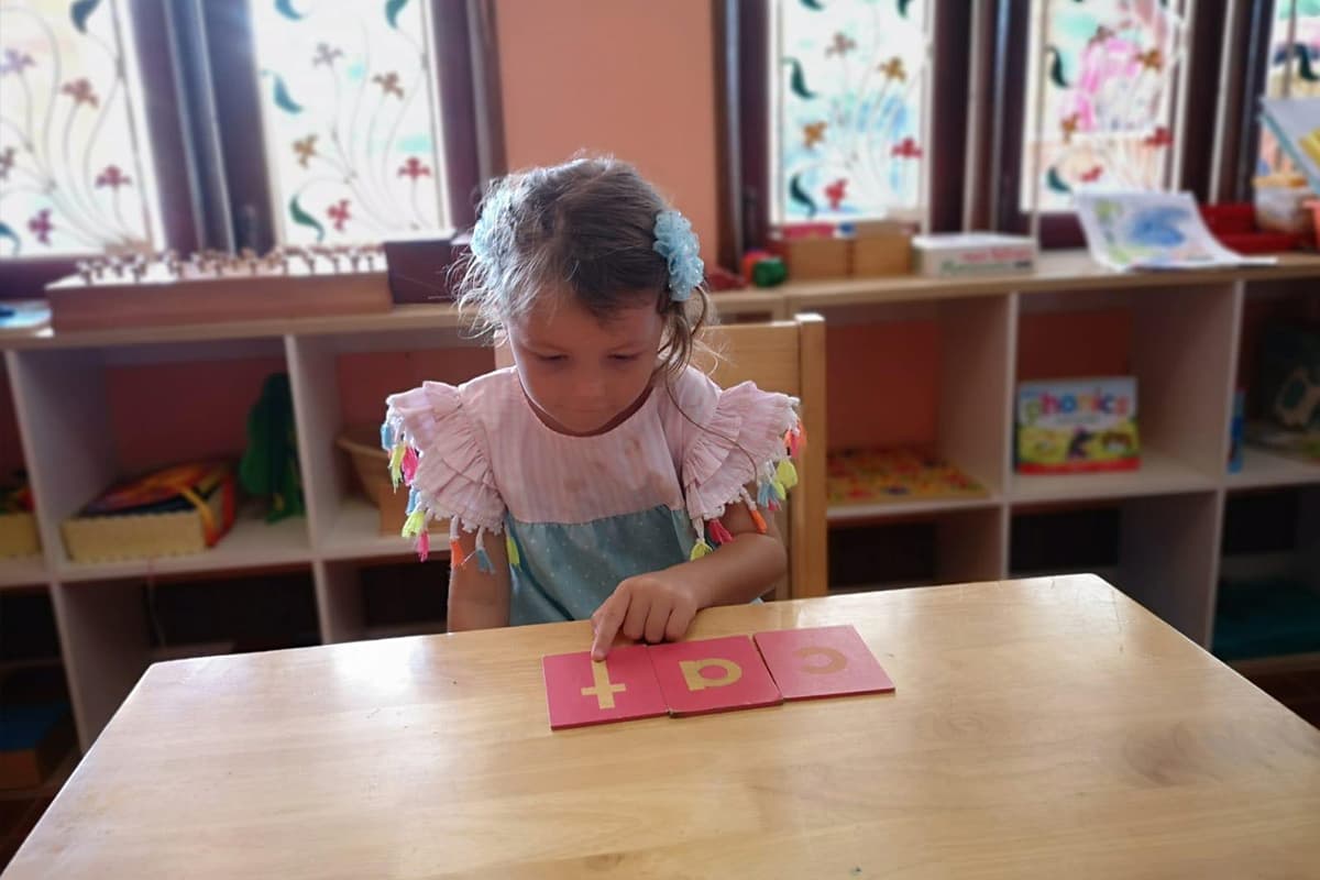 A child working quietly at a table in the classroom
